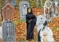  ??  ?? Carol Comeau has nearly 150tombsto­nes and a variety of ghosts, skeletons, monsters and other scary things in her front yard.