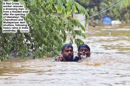  ?? REUTERS ?? A Red Cross worker rescues a drowning man from a flooded area after the opening of Idamalayr, Cheruthoni and Mullaperiy­ar dam shutters, following heavy rains in India yesterday.