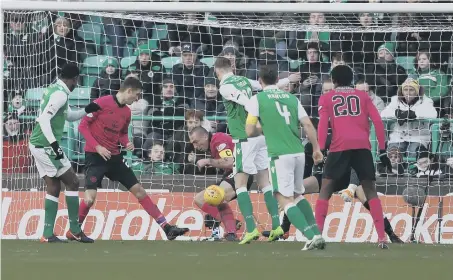  ??  ?? Efe Ambrose (left) scores Hibernian’s first goal of the game in their 2-2 draw with Celtic yesterday in the Ladbrokes Scottish Premiershi­p.