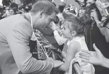  ?? BEN BIRCHALL / PA VIA AP ?? Prince Harry, left, greets a young well-wisher during a walkabout with Prince William outside Windsor castle on Friday, ahead of Harry’s wedding to Meghan Markle on Saturday. Right, Markle, left, and her mother, Doria Ragland, arrive at Cliveden House...