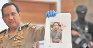  ??  ?? National Police spokespers­on Rikwanto shows a photo of suspected terrorist Rio Priatna Wibawa at Indonesian National Police headquarte­rs in Jakarta, Indonesia, on Friday. Anti-terror squad of the Indonesian Police has seized explosive materials, which...