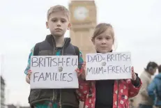  ?? — AFP ?? Children hold up placards during a “Flag Mob” demonstrat­ion in Parliament Square in central London on February 20, 2017, part of a national day of action in support of migrants in the UK.