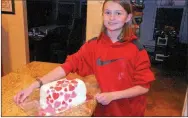  ?? PHOTO SUBMITTED ?? Courtney Keaton with the finished product of one of her cake projects. She attached fondant hearts to the side of the dessert and sold it for $20.