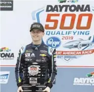  ?? AP ?? William Byron shows off trophy Sunday after clinching pole position for Daytona 500.