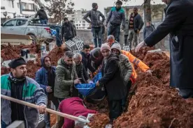  ?? ?? Burial of three earthquake victims at the Nurdağı cemetery. Photograph: Alessio Mamo/ The Guardian