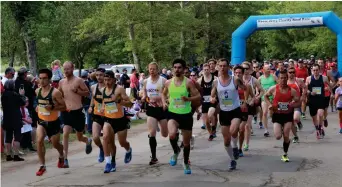  ??  ?? Runners take off from the starting lines at the 2018 Moose Jawg road race.