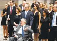  ?? Evan Vucci / Associated Press ?? Former President George W. Bush and his father, former President George H.W. Bush, watch as the casket of former first lady Barbara Bush is loaded into a hearse at St. Martin’s Episcopal Church in Houston on Saturday.