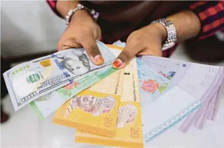  ?? FILE PIC ?? The ringgit will strengthen when global market sentiment improves, says HSBC.