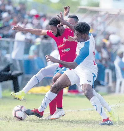  ?? GLADSTONE TAYLOR/MULTIMEDIA PHOTO EDITOR ?? Dunbeholde­n striker Dean-Andre Thomas (left) is challenged by Portmore United’s Roshane Sharpe and Emilio Rousseau (right) for possession during a Red Stripe Premier League game on Sunday, September 15, 2019.