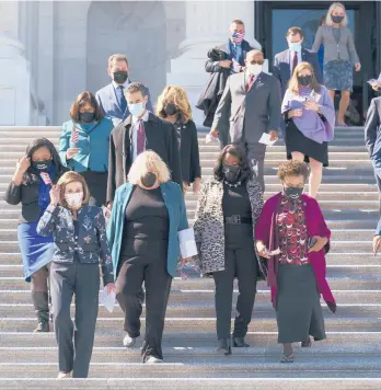  ?? J. SCOTT APPLEWHITE/AP ?? House Speaker Nancy Pelosi, D-Calif., second left, and members of the Democratic Caucus walk down stairs Wednesday outside the U.S. Capitol to address reporters.