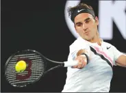  ?? AP/VINCENT THIAN ?? Switzerlan­d's Roger Federer makes forehand return to France's Richard Gasquet on Saturday during the Australian Open.