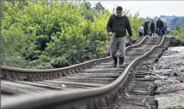  ?? ASSOCIATED PRESS ?? AMEL EMRIC Rising waters have warped train tracks in Bosnia, where the rain has caused nearly 300 landslides.