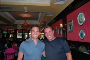  ?? The Associated Press ?? BASEBALL CARD JOURNEY: Brad Balukjian, left, stands with former major league outfielder Lee Mazzilli on July 18, 2015, in Rye, N.Y. Balukjian tore open a pack of 1986 Topps baseball cards, chewed the stale, brittle bubblegum and then planned a journey most sports fans could only dream about. The self-funded trip in 2015, to meet every player whose image appeared on those old pieces of cardboard, cost about $8,000 and took him across 30 states over 11,341 miles in 48 days — fueled by 123 cups of coffee.