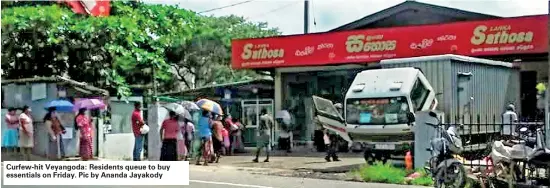  ??  ?? Curfew-hit Veyangoda: Residents queue to buy essentials on Friday. Pic by Ananda Jayakody