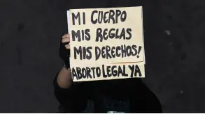  ?? ?? A woman holds a sign reading “My body, my rules, my rights! Legal abortion now!” during a march demanding the decriminal­ization of abortion on the Global Day of Action for Legal and Safe Abortion in Latin America and the Caribbean, in San Salvador.