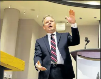  ?? FRED CHARTRAND/CANADIAN PRESS ?? Stephen S. Poloz, governor of the Bank of Canada, answers questions after delivering a speech at Ottawa City Hall council chambers on Thursday. Many analysts would not be surprised if Poloz cuts borrowing costs to stimulate the lagging economy.