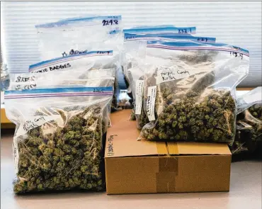  ?? ALANA PATERSON / NEW YORK TIMES ?? Bags of cannabis sit at a dispensary Oct. 9 in Vancouver, Canada. At least three provinces are facing a dearth of legal marijuana, and two have seen outlets temporaril­y shut down for lack of supply.