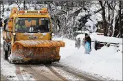  ?? JEFF J MITCHELL / GETTY IMAGES ?? A snowplow clears a road in Balloch, Scotland, on Thursday. Hundreds of drivers were trapped in their cars overnight and authoritie­s said everyone except emergency workers should stay off roads.