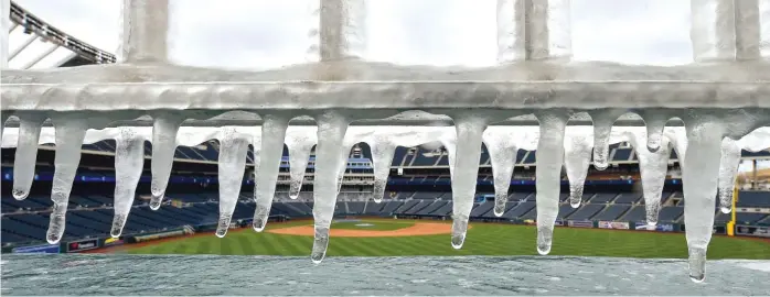  ?? AP ?? Ice forms on the railing above the fountains at Kauffman Stadium in Kansas City, Mo., before a game Sunday between the Royals and Angels. The game eventually was postponed because of the weather.