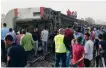  ?? Reuters ?? People surround damaged carriages of a train that was derailed in Toukh, north of Cairo, in April.