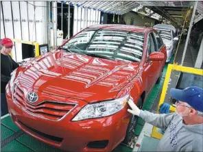  ?? CHARLES BERTRAM / FOR CHINA DAILY ?? Toyota team members Scott Whitaker (left) and Wayne Brooks, inspect a Camry at the Toyota Motor manufactur­ing plant in Georgetown, Kentucky in the United States.