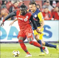  ?? CP PHOTO ?? In this file photo, Toronto FC’s Jozy Altidore, left, takes possession of the ball ahead of New York Red Bulls’ Aaron Long during first-half MLS soccer action Sept. 30 in Toronto.