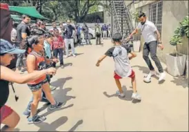  ?? HT PHOTO ?? Virat Kohli plays street football as part of an initiative to encourage children to embrace sports.