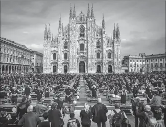  ?? CLAUDIO FURLAN / ASSOCIATED PRESS ?? Entertainm­ent workers gather outside the Duomo cathedral in Milan on Saturday to protest against the Italian government’s policies in response to the coronaviru­s.