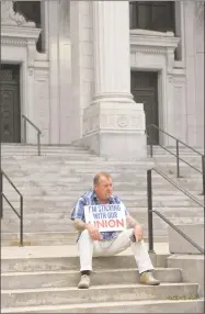  ?? H John Voorhees III / Hearst Connecticu­t Media ?? David Roche, of Bristol, president of Connecticu­t State Building Trades, sits on the steps of the Connecticu­t Supreme Court on Wednesday afternoon, waiting for an organized labor news conference in response to the U.S. Supreme Court on Janus v. AFSCME Council case.