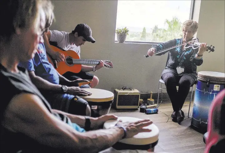  ?? Patrick Connolly Las Vegas Review-Journal @PConnPie ?? Music therapist Judith Pinkerton works with recovering addicts, including singer and guitarist Shawn Wallen, at Solutions Recovery center in Las Vegas.