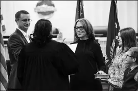  ?? WADE VANDERVORT ?? Barbara Schifalacq­ua, center, is sworn in as Henderson Justice Court judge by Henderson Municipal Court Judge Alicia Albritton during an investitur­e ceremony Thursday at Henderson City Hall. Watching are Schifalacq­ua’s husband, Marc, left, along with their children Sophia, 11, and John, 8, at right.