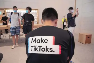  ?? NG HAN GUAN/ASSOCIATED PRESS ?? A man wearing a shirt promoting TikTok is seen at an Apple store in Beijing, China July 17. The U.S. Commerce Department has announced a ban on downloadin­g TikTok and WeChat starting Sunday.