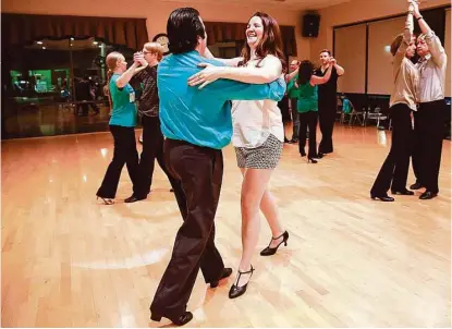  ?? Diana L. Porter / For the Chronicle ?? Tom Chimi and Rachel Walter do the rumba at the Fred Astaire Dance Studio in Katy. “Everyone who comes in goes from zeros to heroes here,” owner Roman Mocharsky says.