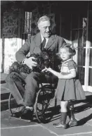  ?? M.L. Suckley /AP ?? President Franklin Roosevelt holds Fala while talking to Ruthie Bie, granddaugh­ter of the caretakers of the Hill Top Cottage at his Hyde Park, N.Y., home in this Feb. 1941 file photo.