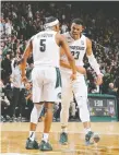  ?? REY DEL RIO/GETTY IMAGES ?? Michigan State’s Xavier Tillman, right, became the Spartans’ career leader in blocked shots, reaching 147 during Tuesday’s win against Iowa.