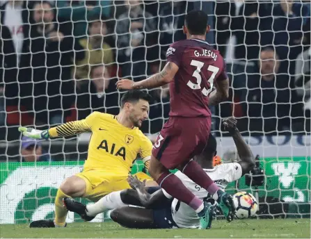  ?? FRANK AUGSTEIN THE ASSOCIATED PRESS ?? Manchester City’s Gabriel Jesus scores during an English Premier League soccer match against Tottenham Hotspur at Wembley Stadium in London on Saturday. Man City won the contest, 3-1.