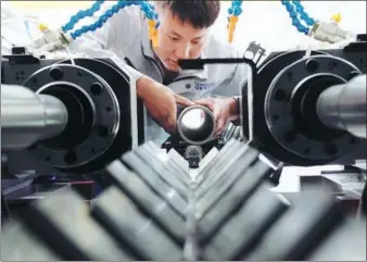  ?? CHEN XIAODONG / FOR CHINA DAILY ?? A technician operates a high-tech production line in Xuanhua, Hebei province.