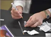  ?? MEDIANEWS GROUP/ DAILY TIMES ?? CVS pharmacist Gina Glancy draws a dosage of the Pfizer BioNTech COVID-19 vaccine during a clinic at The Watermark at Bellingham in East Goshen.