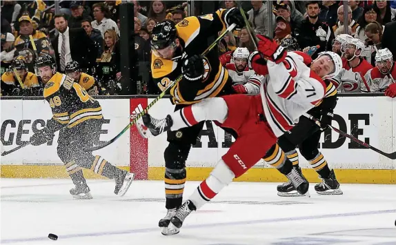  ?? STUART CAHILL / HERALD STAFF FILE ?? NOT COMING BACK? The Bruins’ David Backes hits the Hurricanes’ Lucas Wallmark in Game 2 of the Eastern Conference Finals on May 12, 2019.