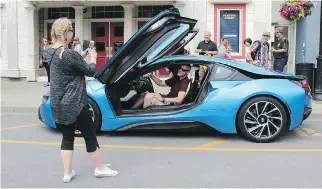  ??  ?? Arto Huhkio of Finland talked his way into getting his picture taken in the i8 at Niagara-on-the-Lake.