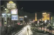  ?? STEVE MARCUS — THE ASSOCIATED PRESS ?? Some of the casinos along the Las Vegas Strip dim their marquee signs for about 10 minutes Sunday to pay tribute to the victims who spent that much time under fire on Oct. 1.