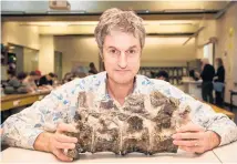  ??  ?? Victoria University palaeontol­ogist James Crampton, with the Hawke’s Bay vertebrae from a cretaceous plesiosaur.