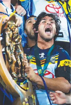 ?? POWERHOUSE: Cowboys jubilant superstar Johnathan Thurston with the NRL trophy after their 2015 victory at ANZ Stadium. Picture: MARK EVANS ??