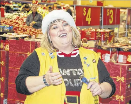 ?? JIM DAY/SALTWIRE NETWORK ?? Walmart greeter Sue Pitre belts out Jingle Bell Rock to the delight of customers making their way around the store during the busy Christmas season.
