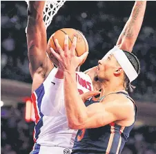  ?? photo — AFP ?? Jalen Duren tries to block a shot by Josh Hart (right) of the New York Knicks during the second half at Madison Square Garden in New York City.