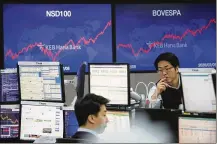  ?? AHN YOUNG-JOON / AP ?? Asian stock markets have surged after President Donald Trump was acquitted in an impeachmen­t trial and China promised aid to businesses reeling from a virus outbreak.