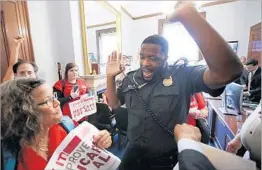  ?? CHIP SOMODEVILL­A/GETTY ?? A U.S. Capitol Police officer forces demonstrat­ors from Texas out of the offices of Sen. Ted Cruz, R-Texas, on Monday during a protest against Republican health care legislatio­n.