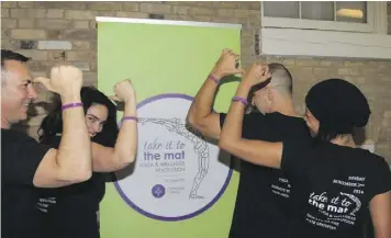  ??  ?? Inaugural “Take it to the Mat” Fundraisin­g Event in Toronto four people wearing
their Lymphoma Canada bracelets.