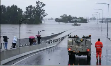  ?? ASSOCIATED PRESS PHOTOS ?? An emergency vehicle blocks access to the flooded Windsor Bridge on the outskirts of Sydney, Australia, July 4.