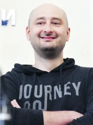  ?? SERGEI SUPINSKY / AFP / GETTY IMAGES ?? Not long after activists were hanging portraits of slain journalist Arkady Babchenko to the fence of the Russian embassy in Kyiv, Babchenko appeared at a news conference.